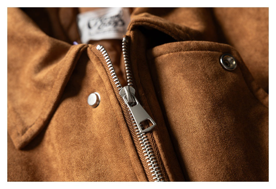 Close-up of a cognac-brown jacket showing a metal zipper, snap fasteners, and a folded collar.