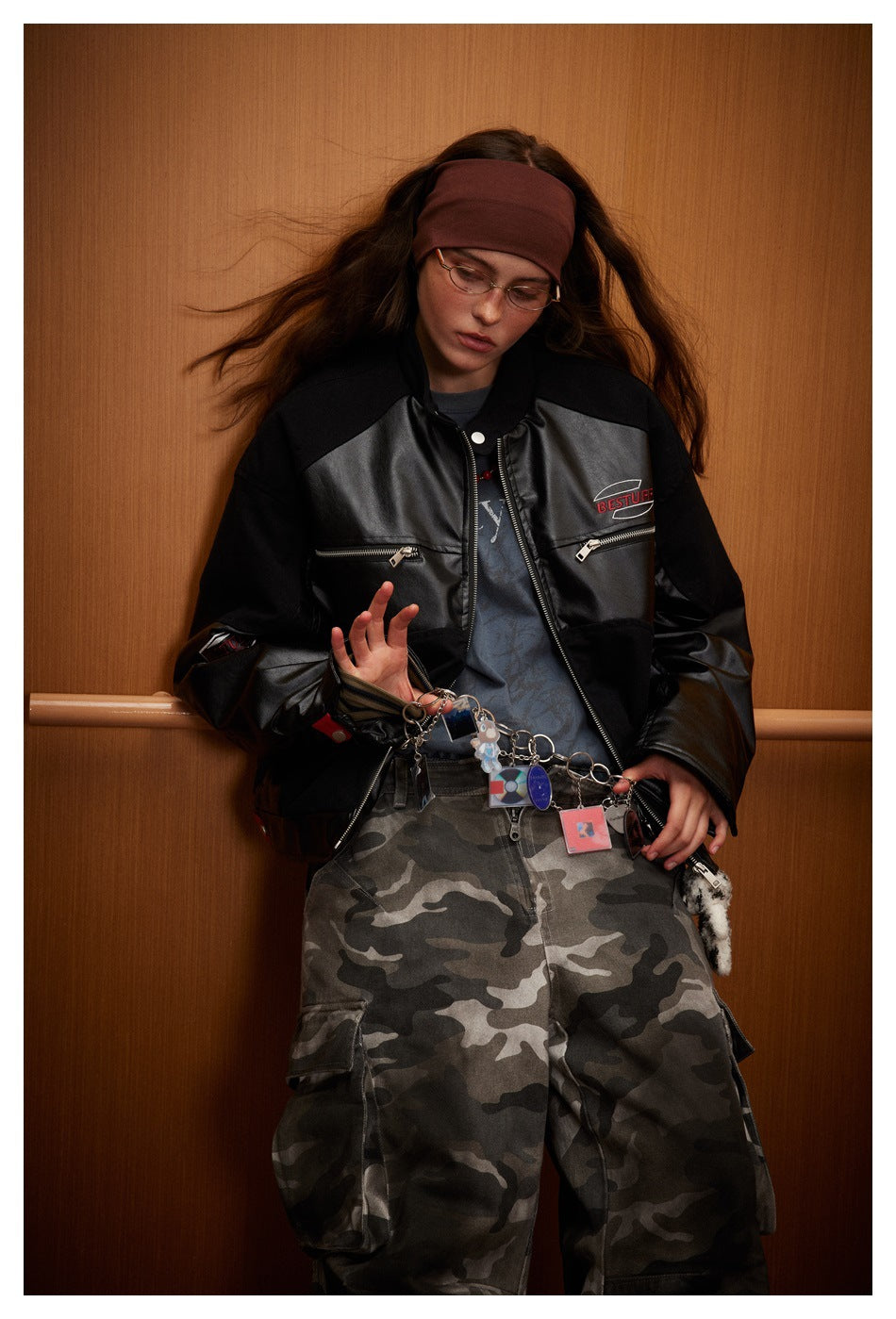 Front view of a model wearing a black color-block jacket with zip pockets and a central zipper.