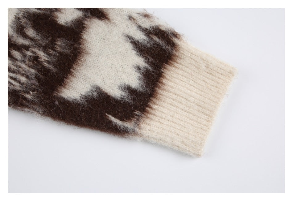 Close-up of a cream ribbed sweater cuff beside a dark brown and cream knit pattern.