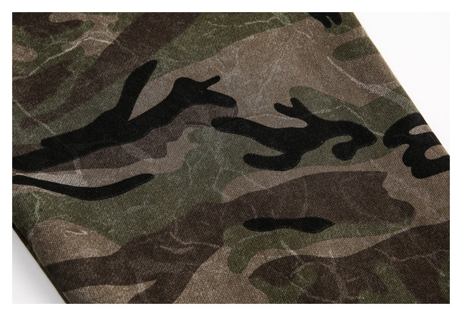 Close-up showing the dark green, brown, and black camouflage pattern on a hoodie sleeve.