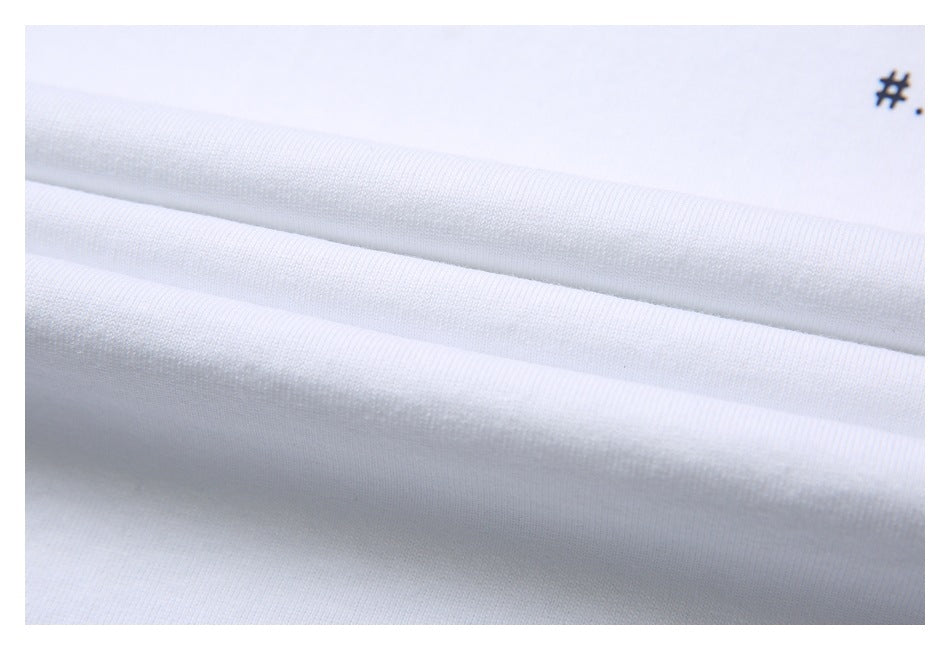 Close-up of white fabric draped in soft folds, with a small black hash mark near the upper right.