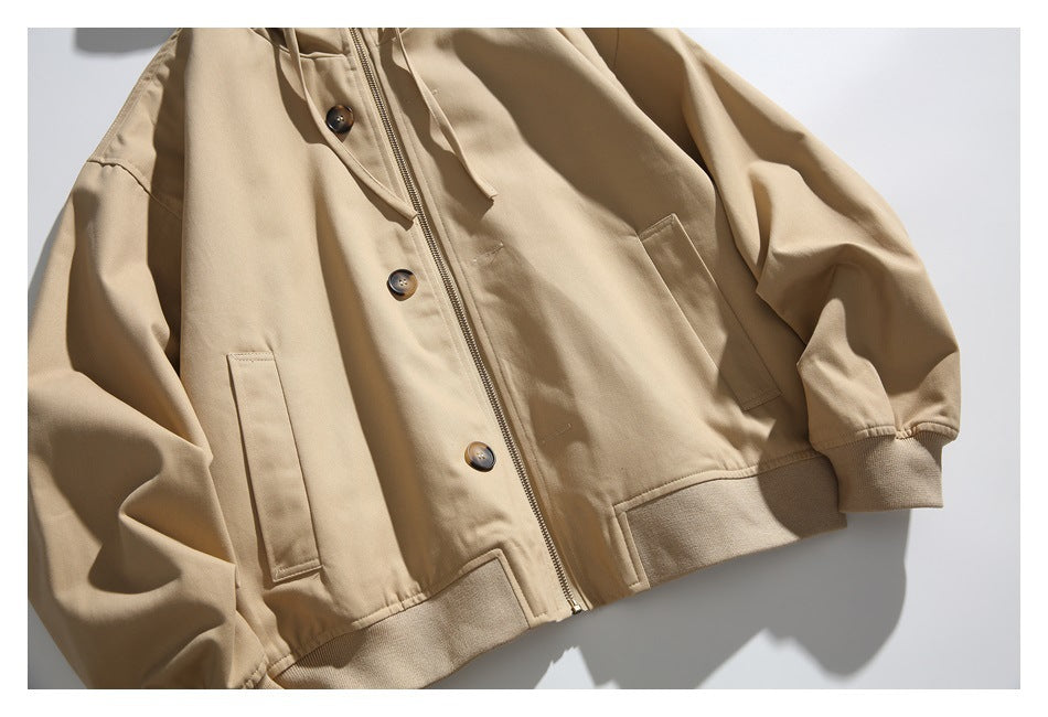 Front view of a tan hooded jacket with a zip closure, buttons, front pockets, and ribbed hem and cuffs.