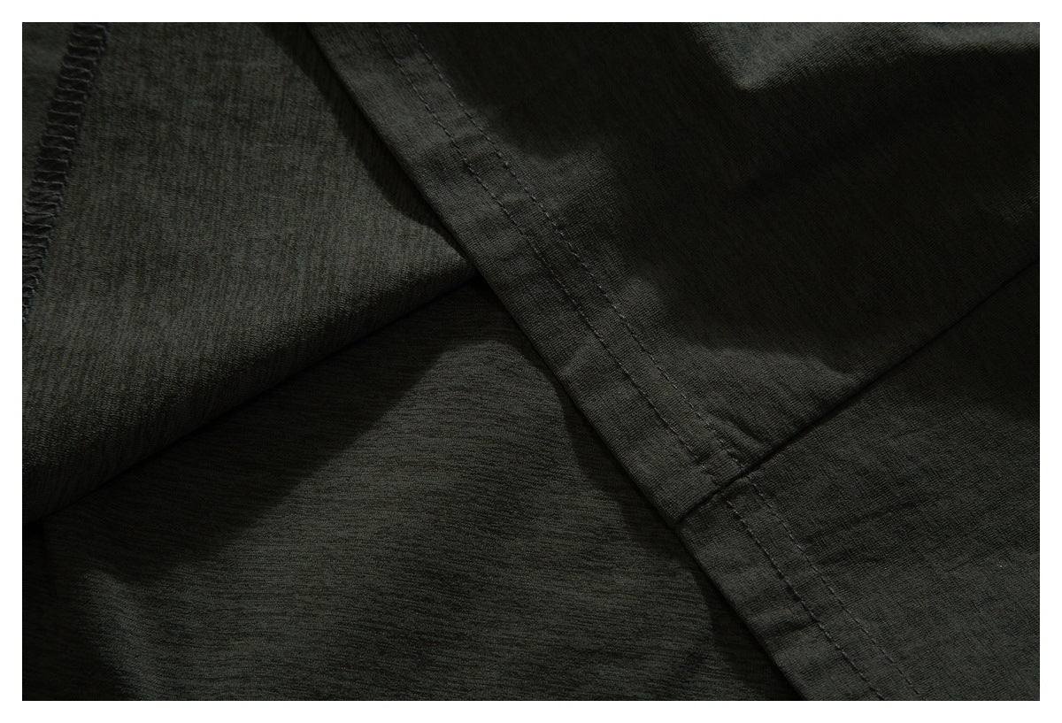 Close-up showing seams and overlocked stitching on dark charcoal fabric.