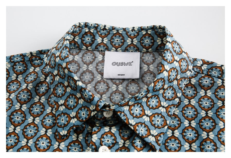Close-up of the shirt collar and sewn neck label, showing a blue, white, and brown floral pattern.