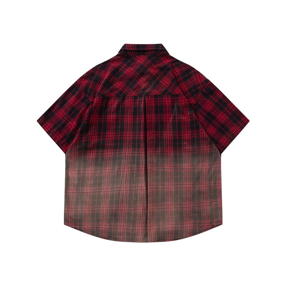 Back view of red plaid short-sleeve shirt with yoke seam, center pleat and faded gradient toward the hem