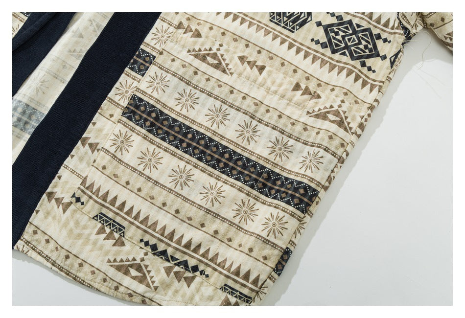 Close-up of a beige garment panel with rows of brown sunbursts and geometric motifs beside a dark navy band.