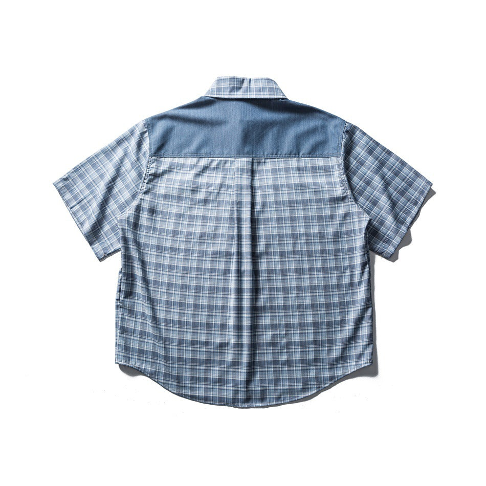 Back view of blue plaid short-sleeve shirt with contrast yoke and curved hem, flat lay