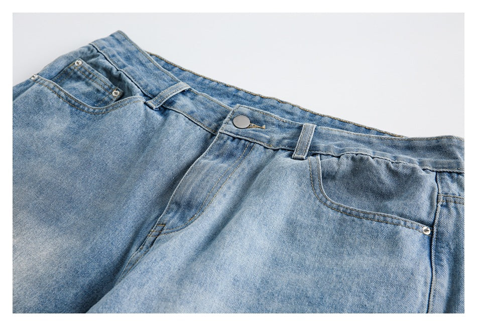 Close-up of the shorts' front waistband, button, belt loops, and pockets.
