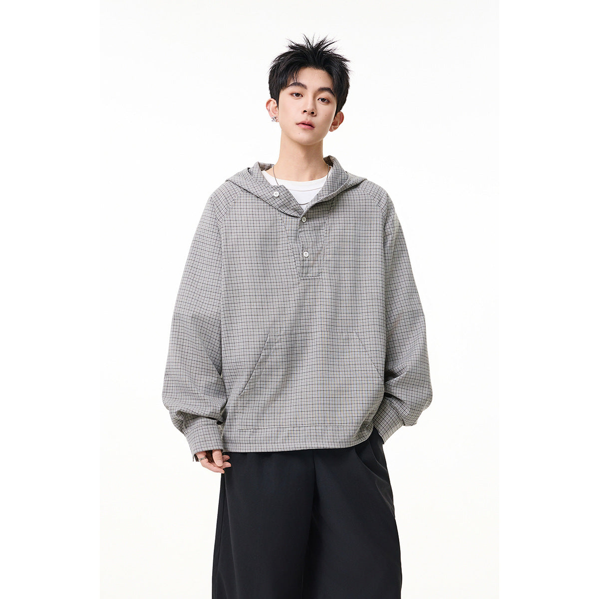 Front view of a model wearing a gray micro-check hooded pullover with a three-button placket and kangaroo pocket.