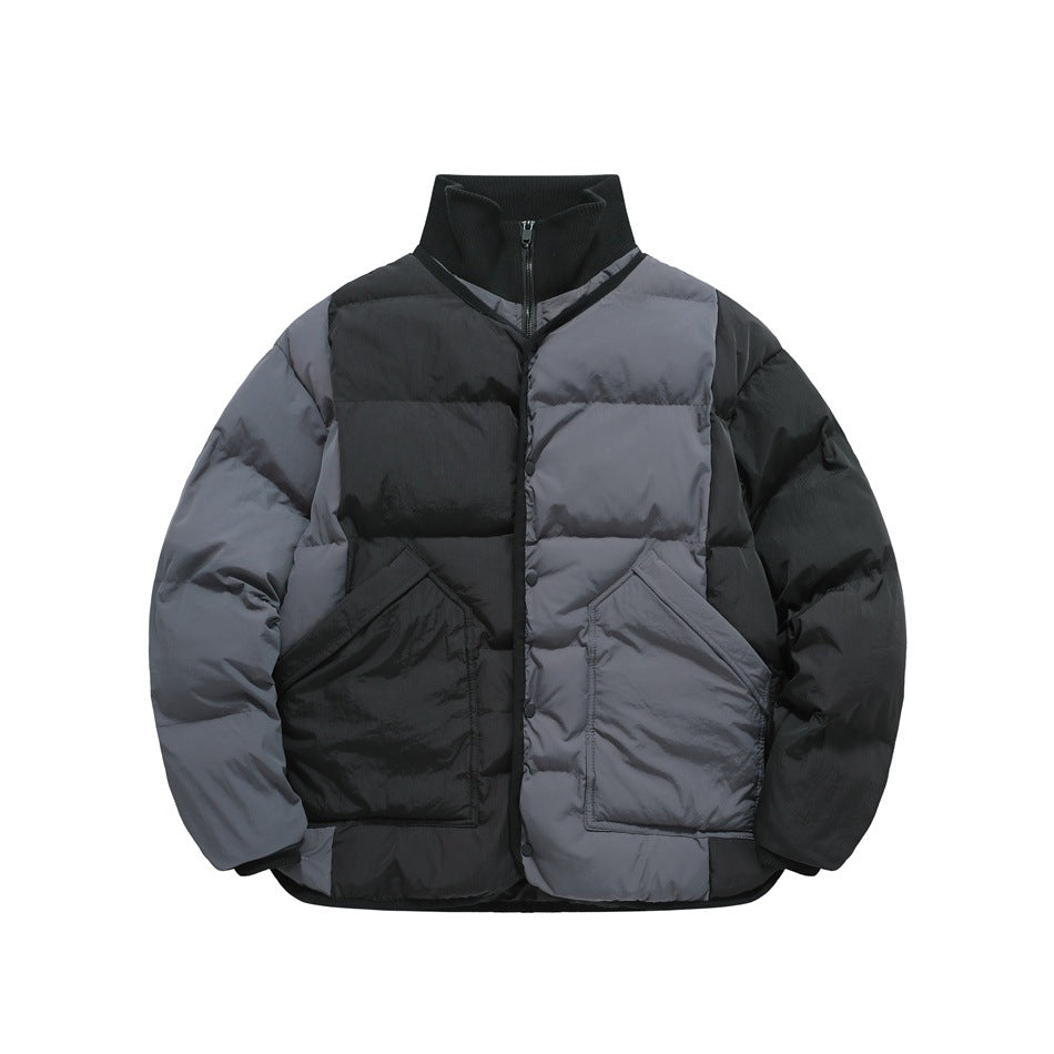 Dark gray and black color-block quilted puffer jacket with black ribbed stand collar, snap placket and angled pockets
