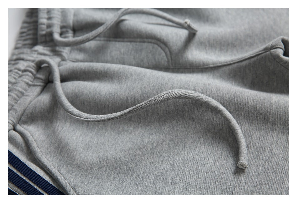 Close-up of the gray sweatpants' drawstring and fabric surface.