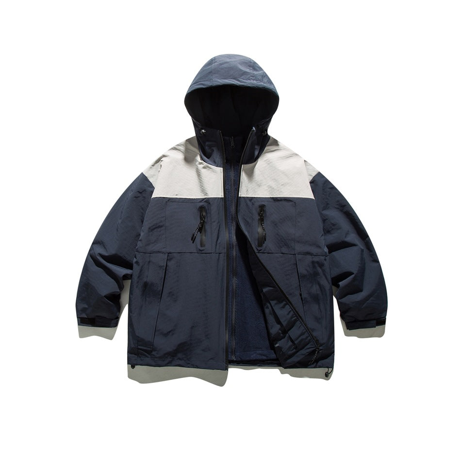 Navy hooded jacket with light gray yoke, unzipped to show a fleece-like textured inner layer with its own zipper