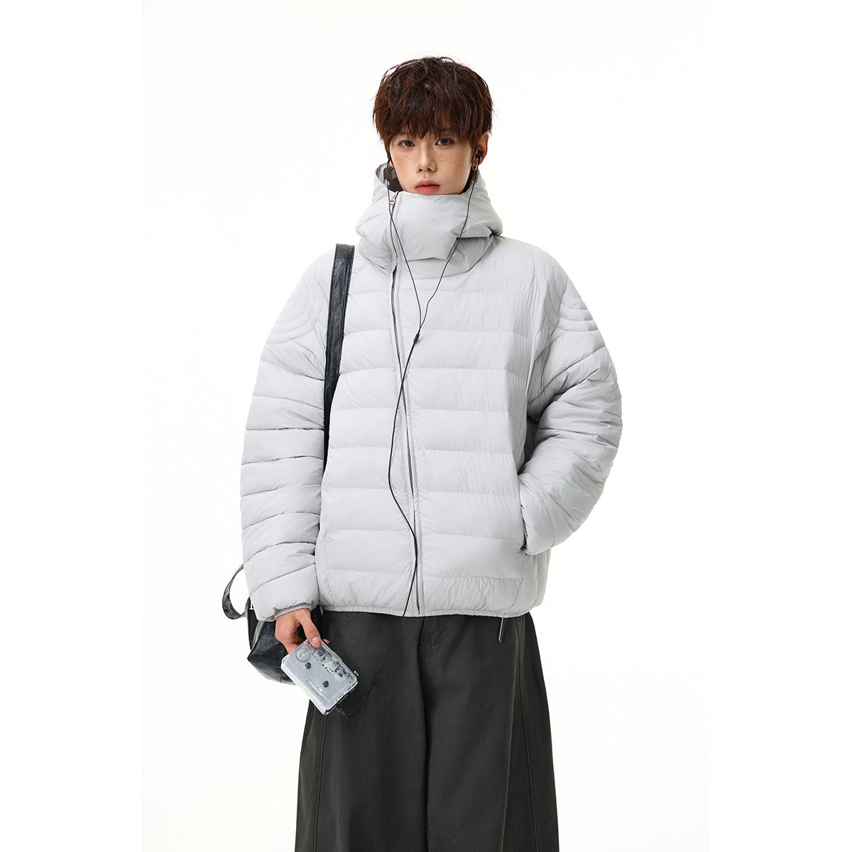 Model wearing a light gray quilted zip-front jacket with a high padded collar.