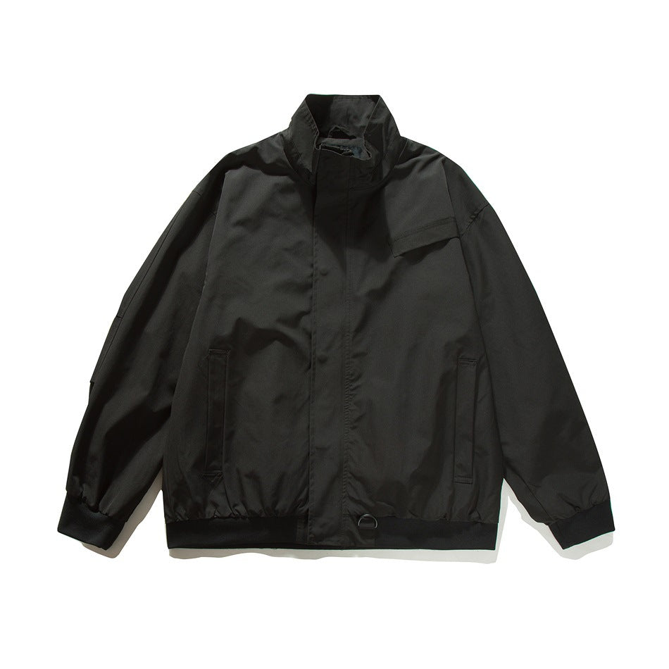 Black stand-collar jacket flat lay, front view with chest flap pocket, slip pockets, ribbed cuffs and hem