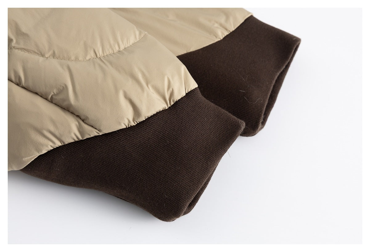 Close-up of the beige padded jacket's dark brown ribbed cuffs.