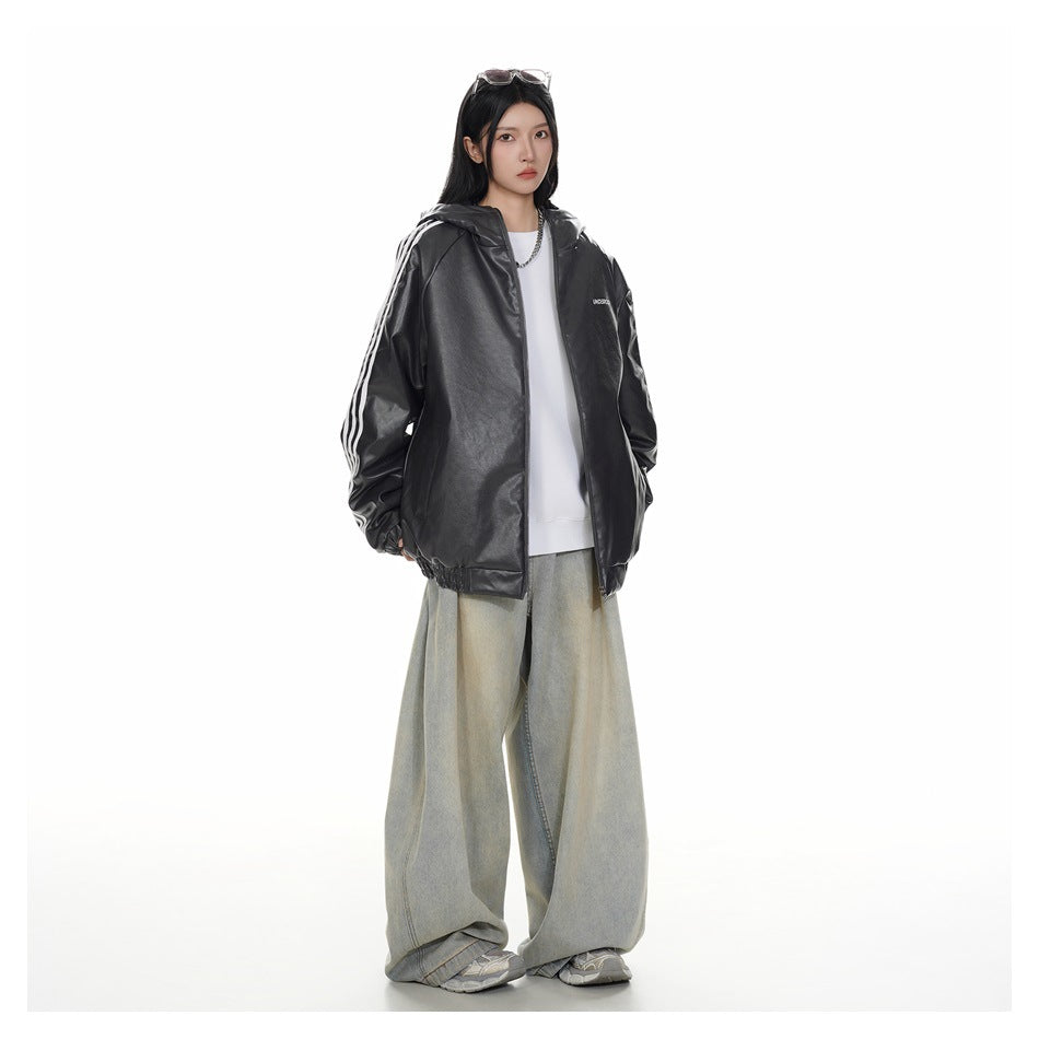 Model wearing an open black hooded jacket with white sleeve stripes and wide light-wash jeans.