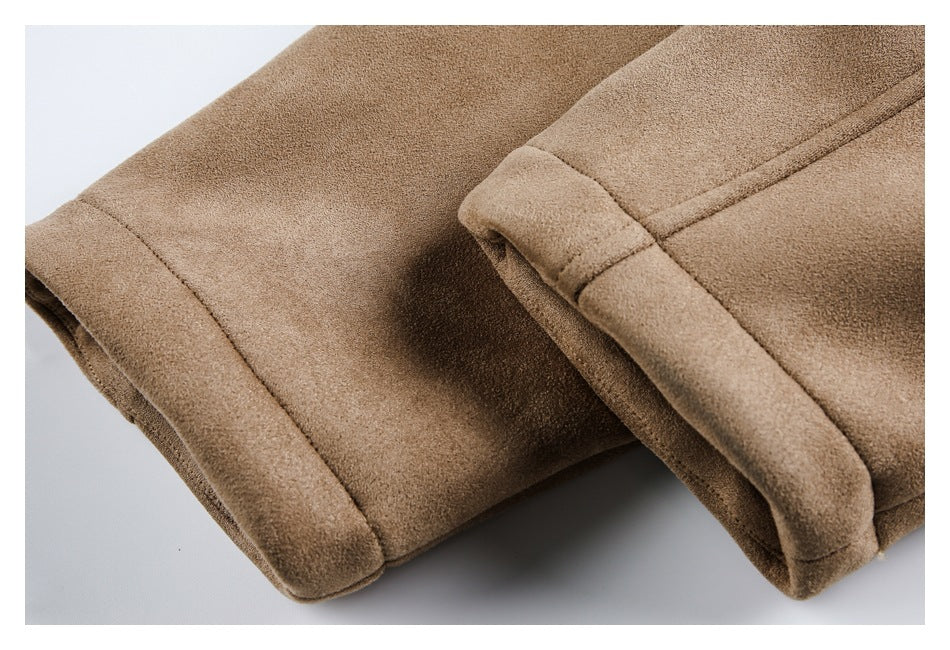 Close-up of the tan jacket's folded cuff and stitched edge against a light background.