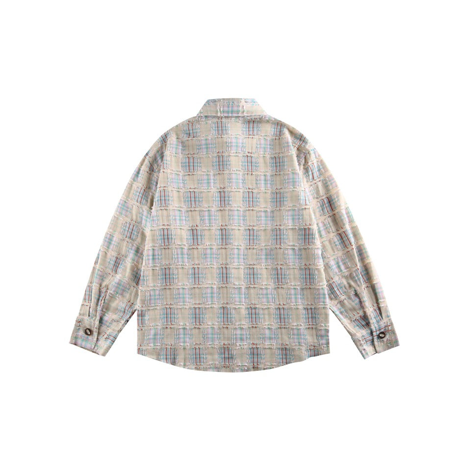 Back view of a cream long-sleeve shirt with a multicolor plaid patchwork pattern and frayed horizontal seams.