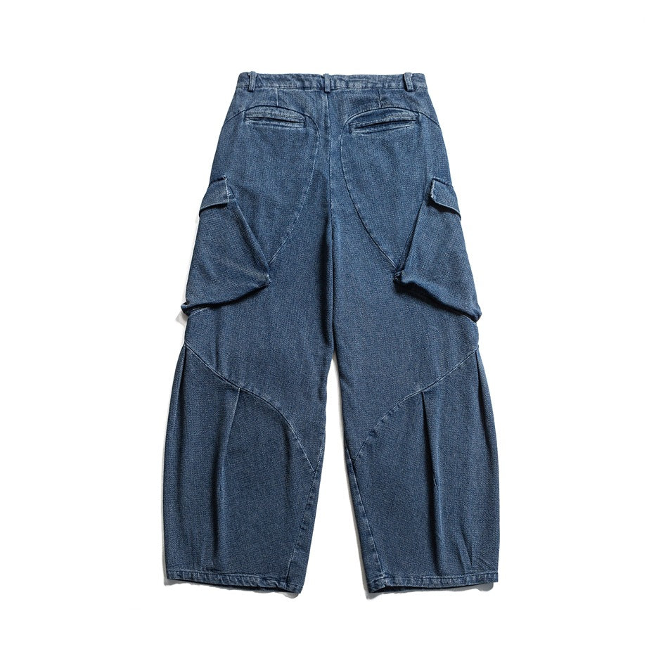 Back view of blue wide-leg trousers with two welt pockets, cargo pockets, and curved panel seams.