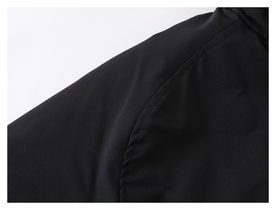 Close-up of the black jacket's shoulder and sleeve seam.
