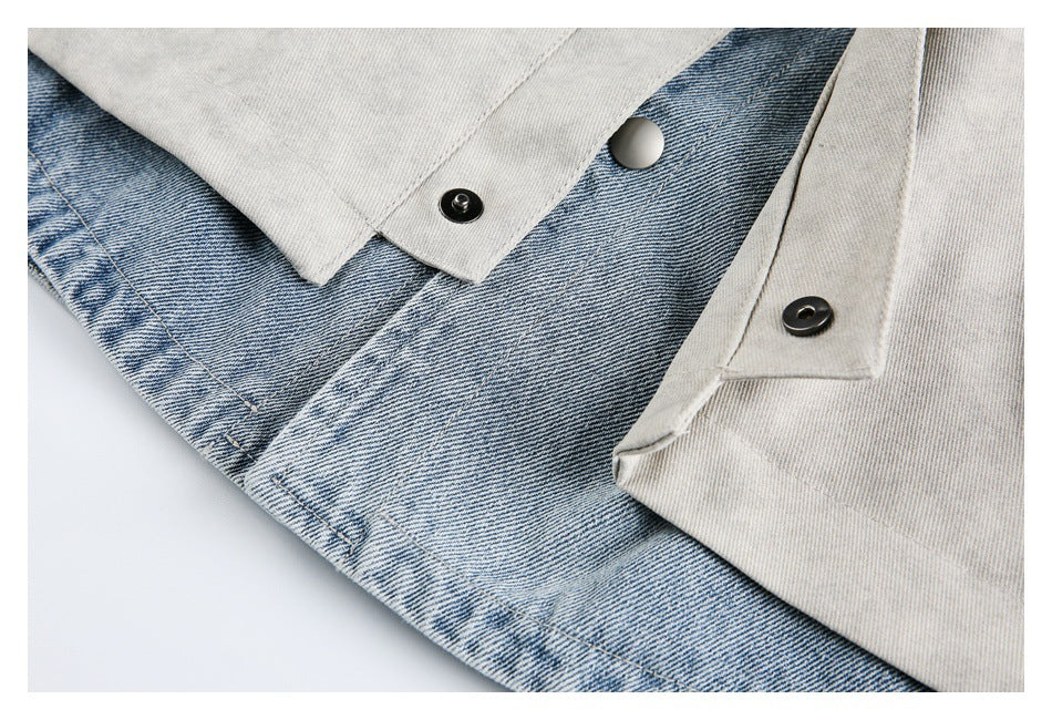 Close-up of the jacket's snap-button placket opened to reveal blue denim fabric beneath.