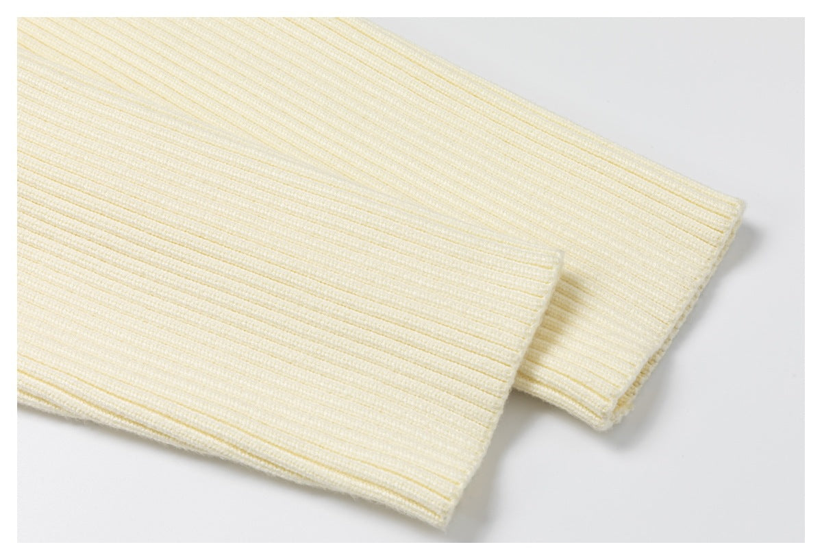 Close-up of the cream jacket's ribbed knit cuff.