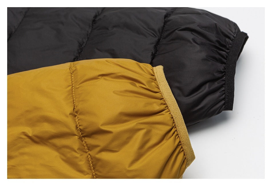 Close-up of mustard and black quilted jacket sleeves showing contrasting cuff edges.
