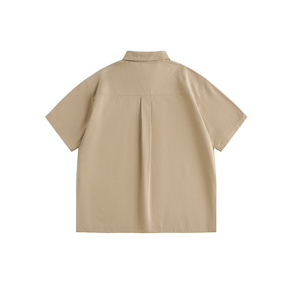 Back view of a beige short-sleeve collared shirt with a center pleat.