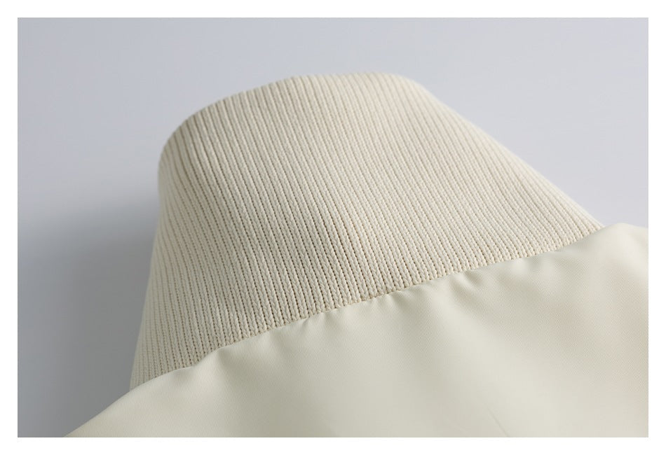 Close-up of a ribbed ivory panel meeting smooth fabric along a curved seam.
