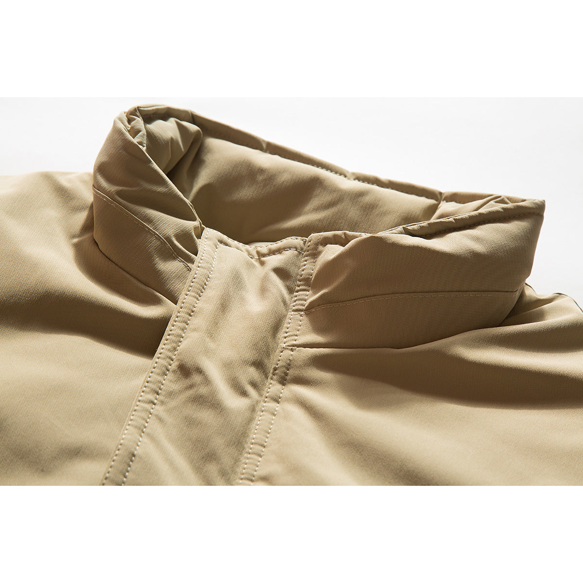 Close-up of a tan jacket collar and front stitching.