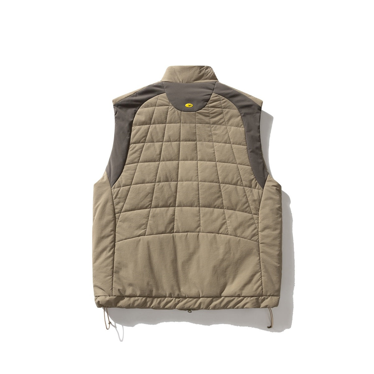 Back of a taupe quilted vest with dark brown shoulder panels, a raised collar, and adjustable hem cords.