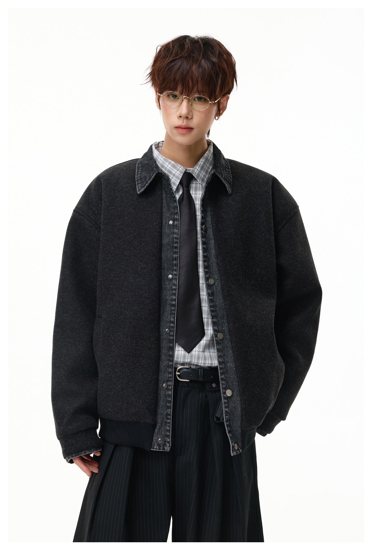 Front view of a model wearing an oversized charcoal jacket with a washed denim collar, snap closure and ribbed hem.