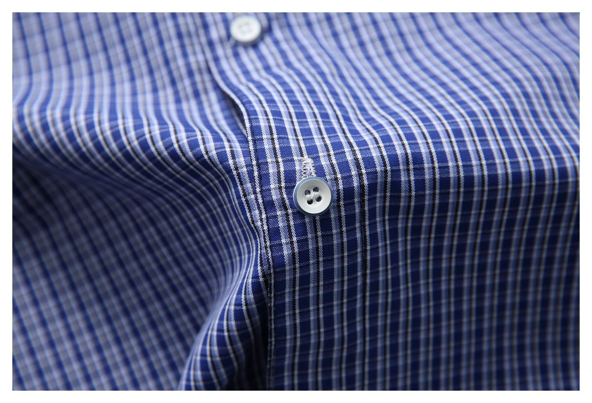 Close-up of a blue-and-white checked shirt placket with two white buttons.