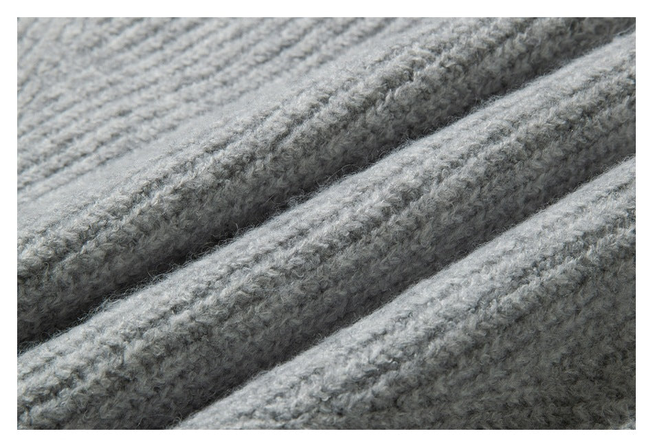 Close-up of the light gray knit fabric, showing its soft, raised texture.
