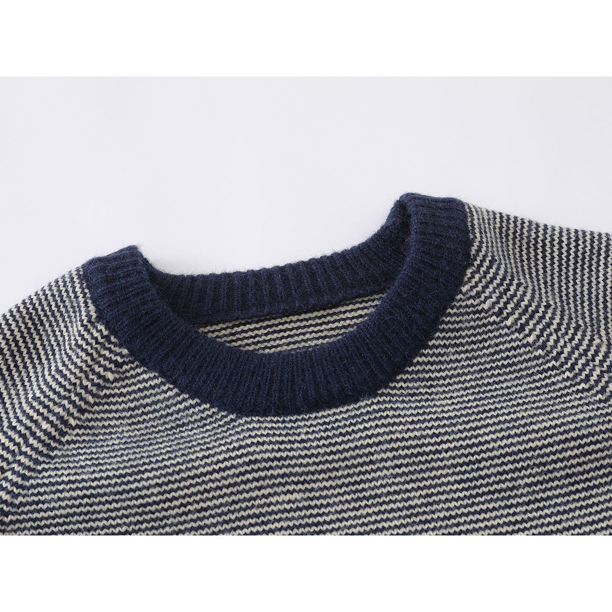 Close-up of a navy ribbed crew neckline on a navy and cream striped knit sweater.