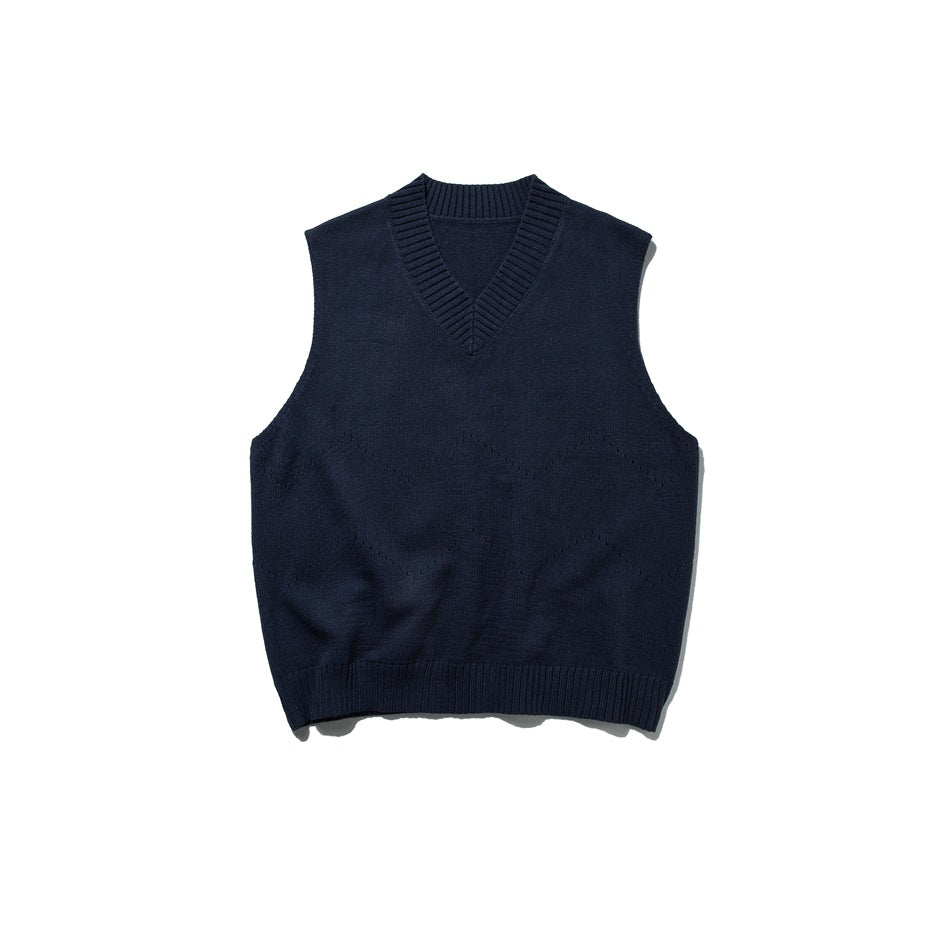 Navy blue knit V-neck sweater vest flat lay with ribbed neckline and hem