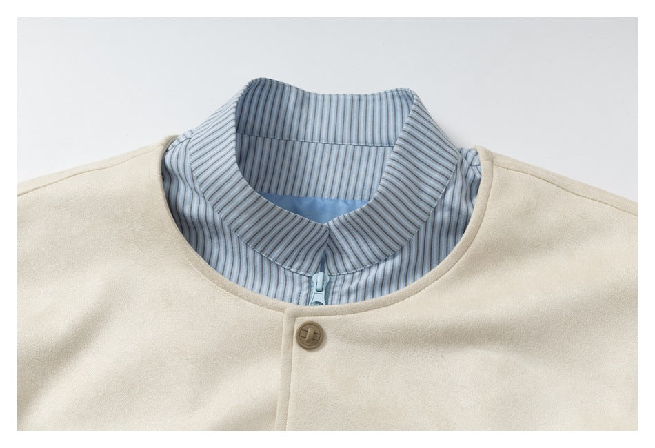 Close-up of an ivory jacket neckline with a blue-and-white striped inner collar, zipper, and front snap button.
