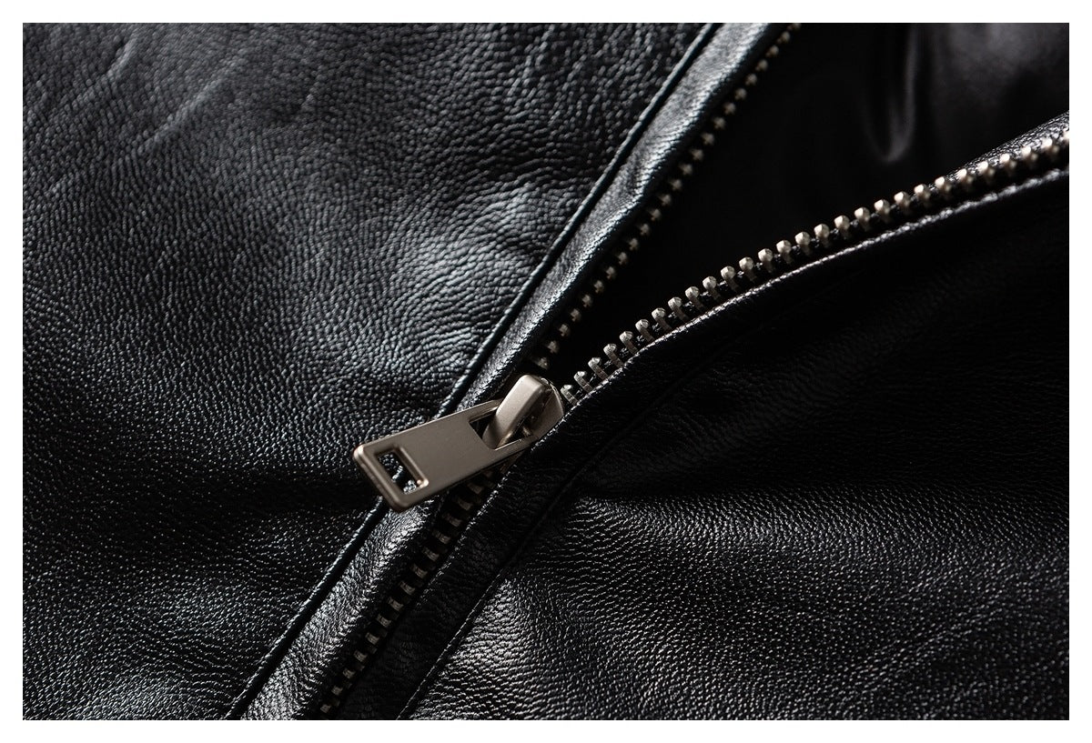 Close-up of a metal zipper on black textured garment material.