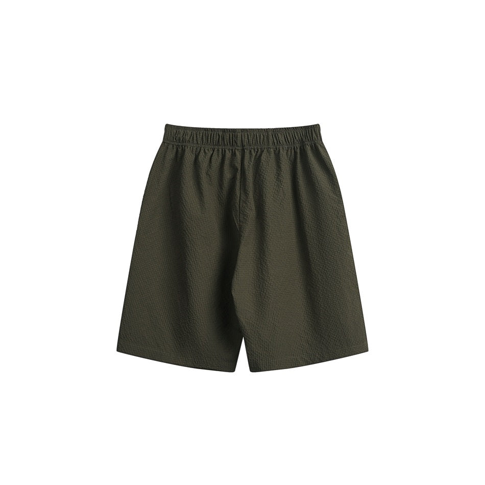 Front view of dark olive shorts with a subtle textured pattern and an elastic waistband, on a white background.