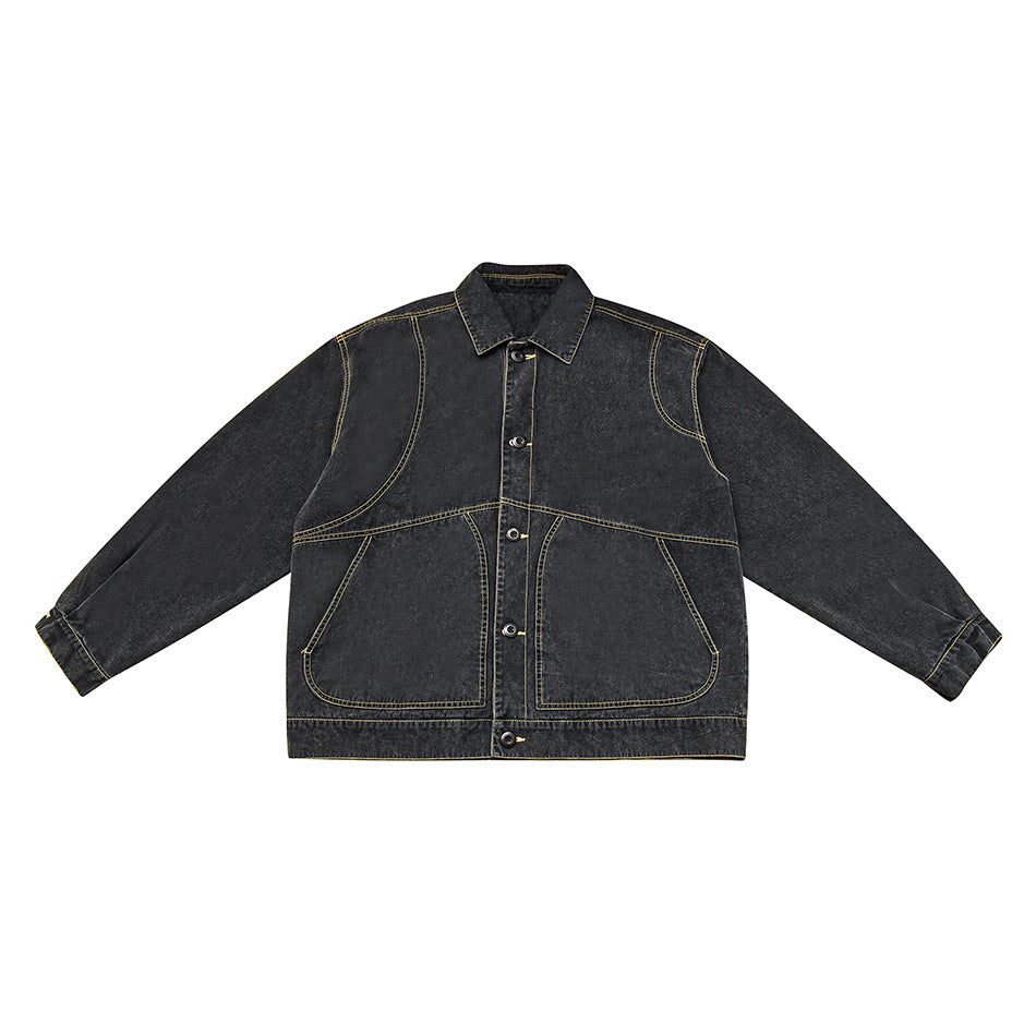 Washed black denim jacket front flat lay with gold topstitching, button front, and large curved pockets