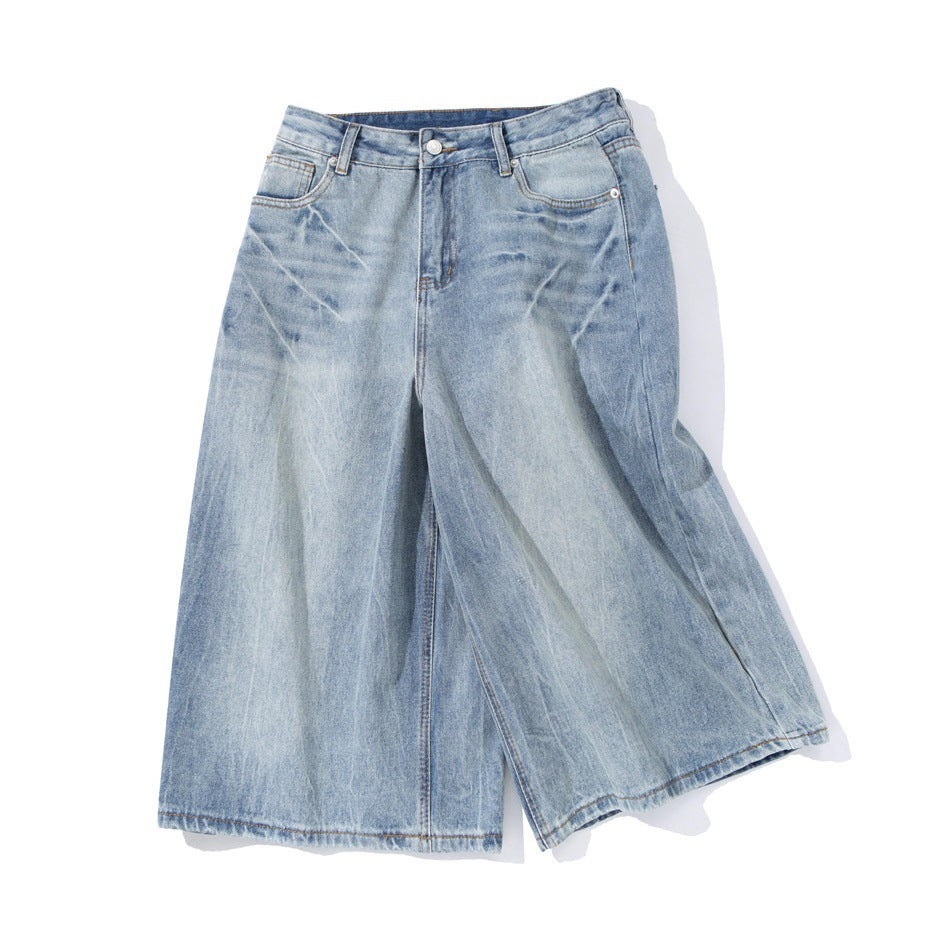 Front view of light blue washed wide-leg denim shorts with a button closure and classic pockets.