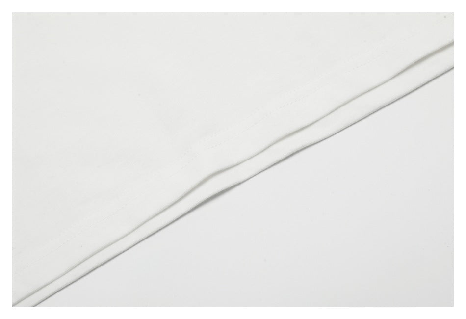 Close-up of a white garment hem with a narrow line of stitching.