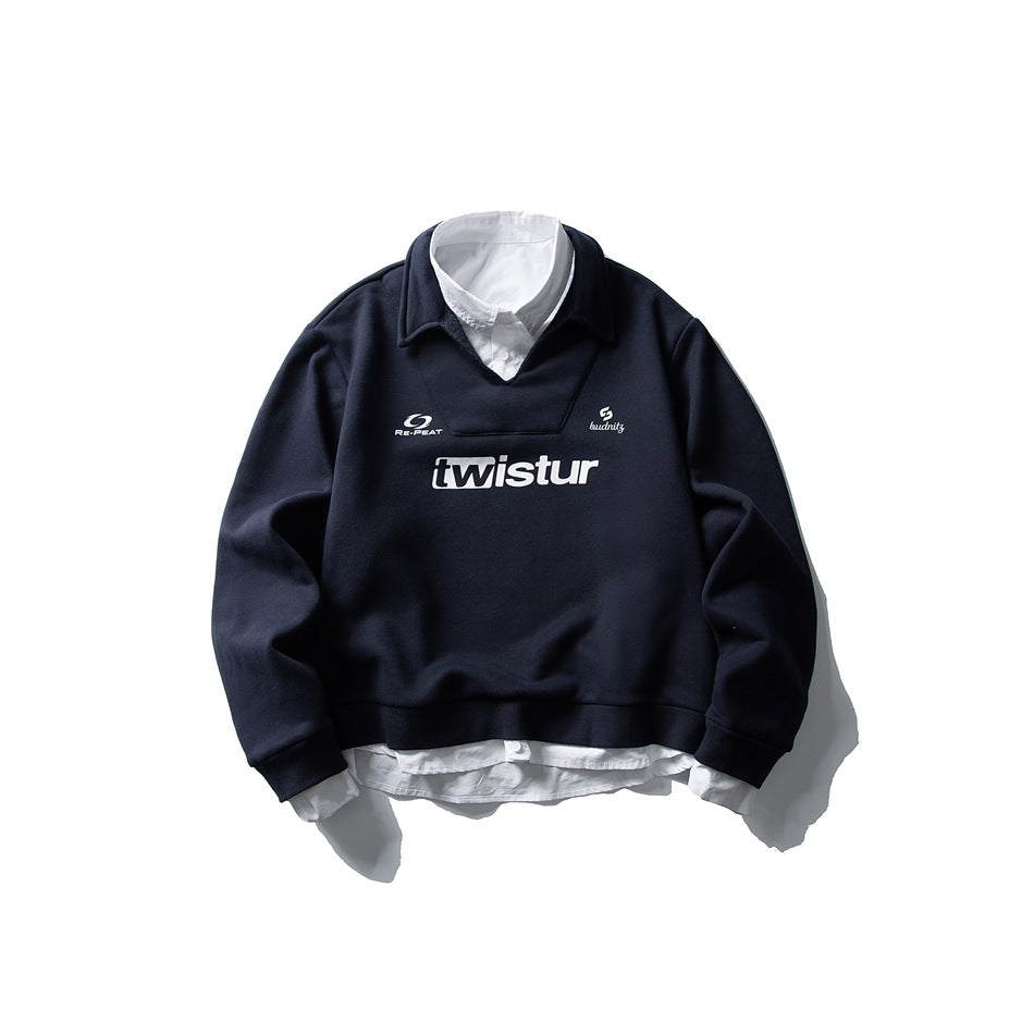 Navy sweatshirt with white shirt collar and hem layered underneath and a white 'twistur' chest print, flat lay