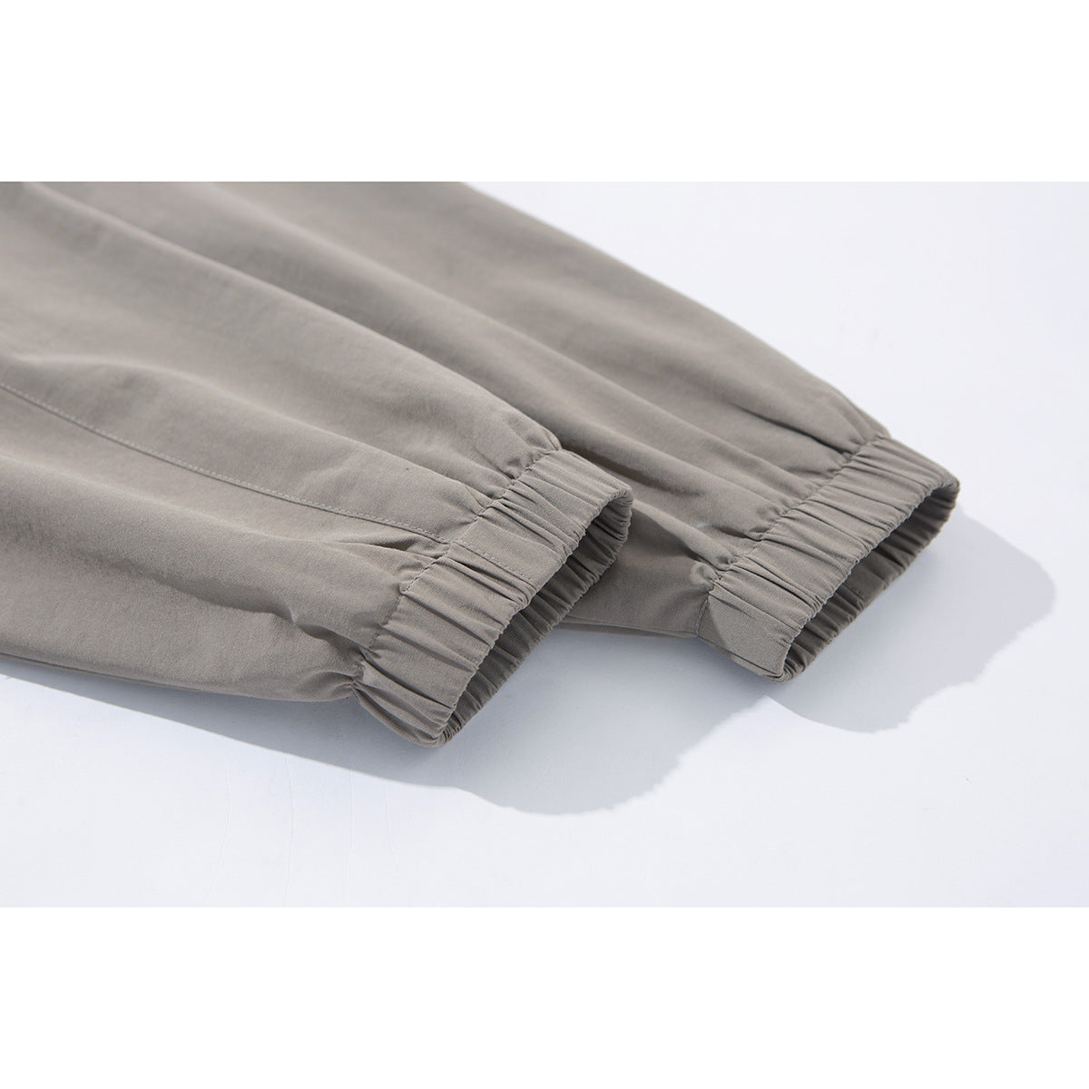 Close-up of the taupe jacket's long sleeves and gathered elastic cuffs.
