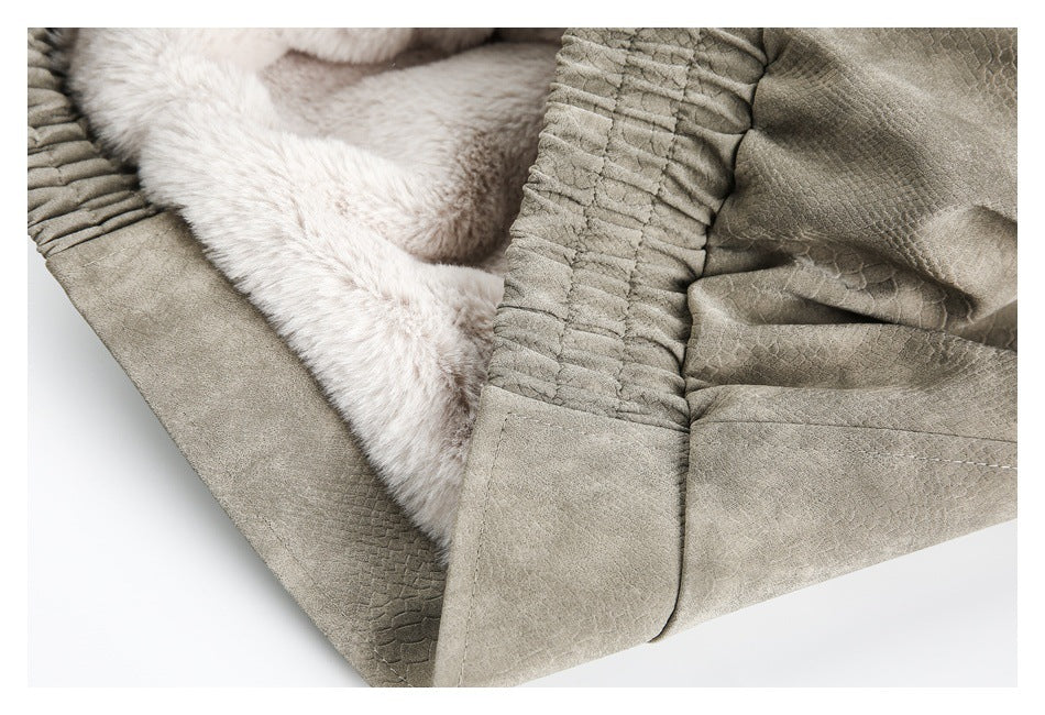 Close-up of the taupe-gray jacket opened to show its soft, pale faux-fur lining and gathered edge.