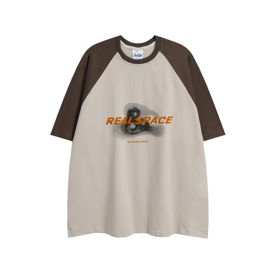 Brown and beige raglan short-sleeve T-shirt with orange lettering and graphic on chest, flat lay