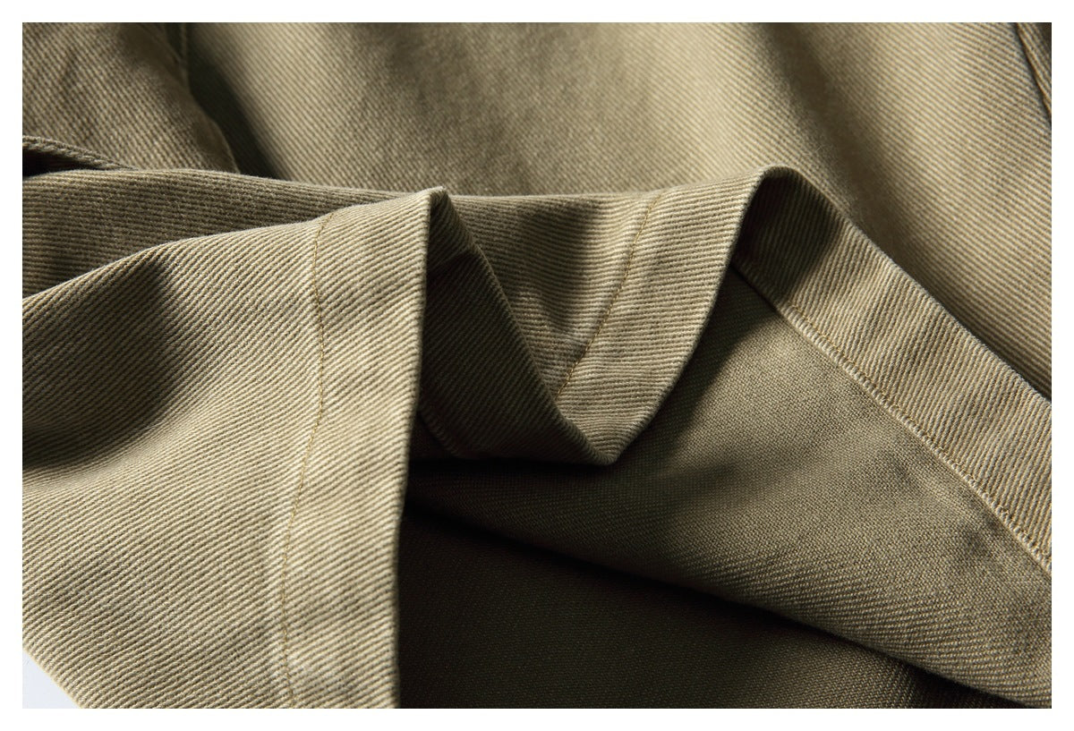 Close-up of tan twill fabric folds and stitched edges.