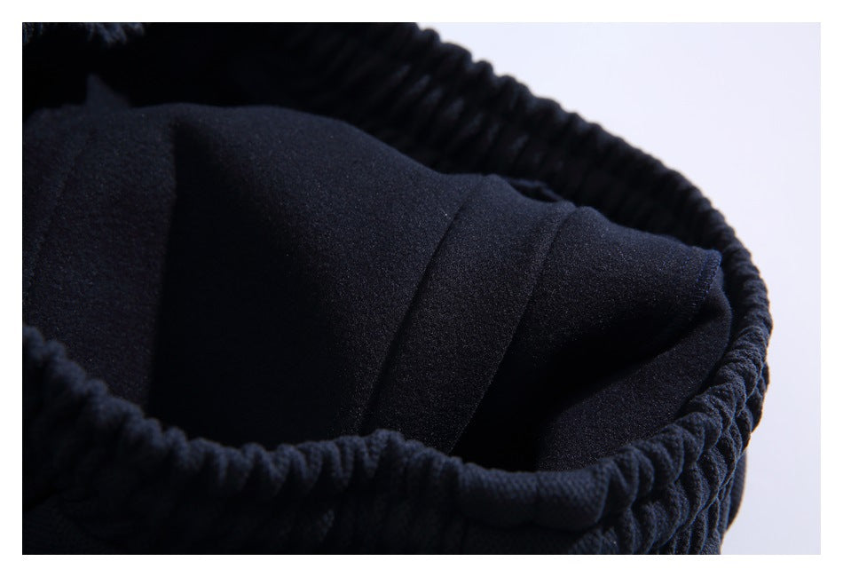 Close-up of the gathered elastic waistband and dark interior of a black garment.