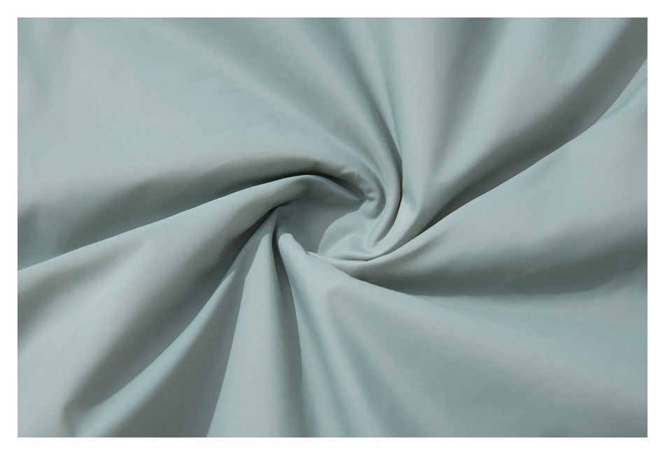 Close-up of pale blue-gray fabric draped into soft folds.