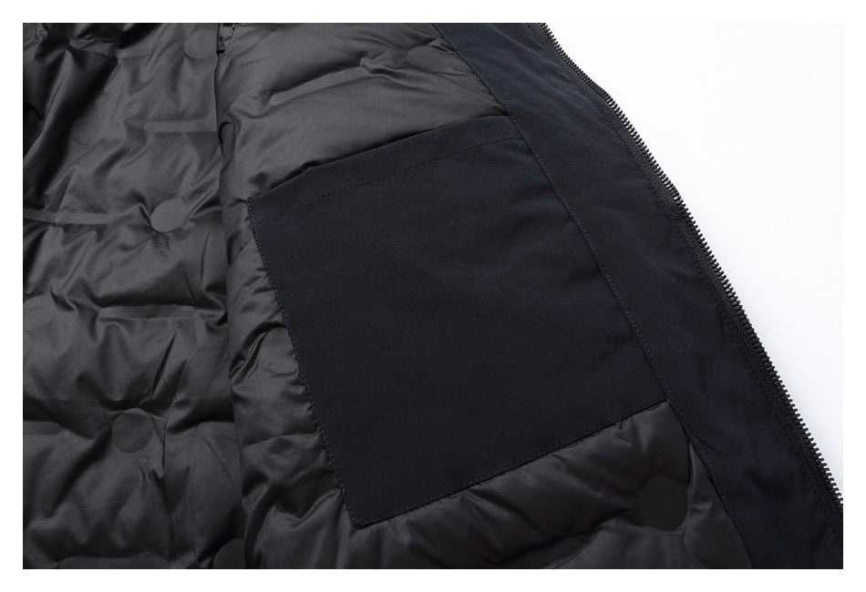 Inside a black jacket, showing a large rectangular pocket beside the zipper.